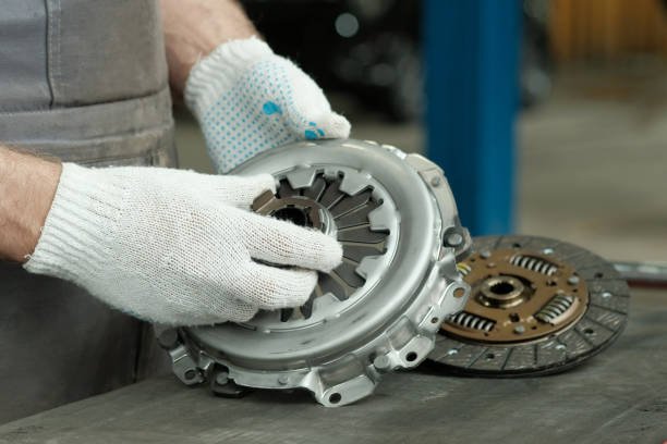 istockphoto-2148654886-612x612 A new clutch kit is in the hands of an auto mechanic. Control of the serviceability of the leading, driven and exhaust bearings.