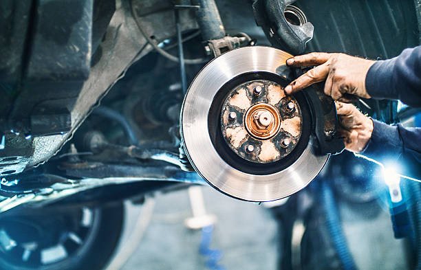 istockphoto-498887346-612x612 Closeup of unrecognizable male mechanical replacing worn out brake pads on a vehicle. The wheel has been removed and the car is lifted up on a jack. Visible braking disc. Side view.