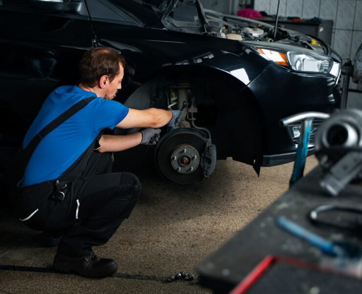 male-mechanic-working-auto-repair-shop-car (1)